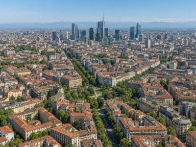 vista aerea dei quartieri residenziali di milano con palazzi, viali alberati e skyline di porta nuova sullo sfondo